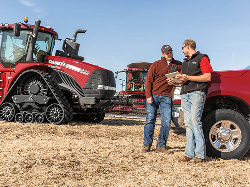 Precision Farming Specialist with customer and Case IH Quadtrac in field