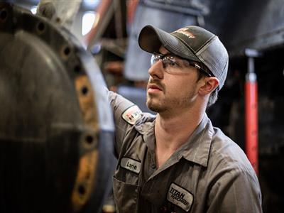 Service Page_Employee Service Technician working on Case IH equipment with a grinder