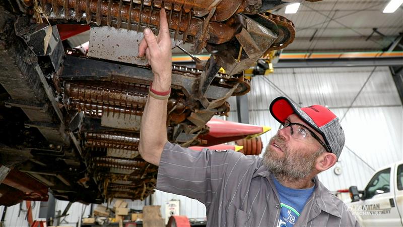 Titan Machinery Service Technician working on a corn header