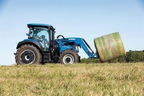 New Holland T5.130 Tractor New Holland T5.130 Tractor in field with hay bale spears